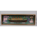 A cased model of the Titanic with associated pictures and information, L 107cm x H 34cm x D 11cm.