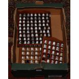 A box of thimbles and wall mounted display cases to include ceramic and metal examples.