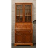 A yew wood bureau bookcase with fitted interior.