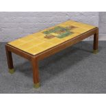 A 1970s tiled top teak coffee table.