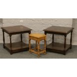 A pair of carved oak lamp tables along with a small oak occasional table.