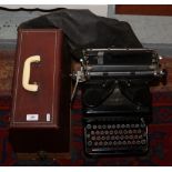 A cased Singer 185K electric sewing machine, along with a vintage typewriter.