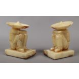 A pair of novelty alabaster bookends formed as seated Mexicans.