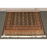 A blue ground Bokhara rug with geometric border, 230cm x 160cm.