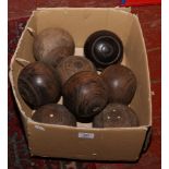 A collection of turned wood lawn bowls.