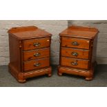 A modern pair of pine effect bedside chest of three drawers.