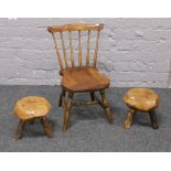 A pair of rustic stools along with a spindle back child's chair.