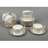 A collection of bone china teawares with gilt floral borders, saucers marked 1250 to base, 26