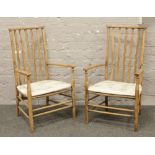A pair of stripped slatback arm chairs.