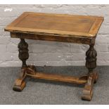 A carved oak occasional table on bulbous supports.