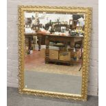 A large gilt framed bevel edge wall mirror, 90cm x 115cm.