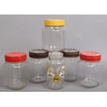 Six vintage glass storage jars, two with Bakelite lids, one c1950s and printed with aeroplanes and