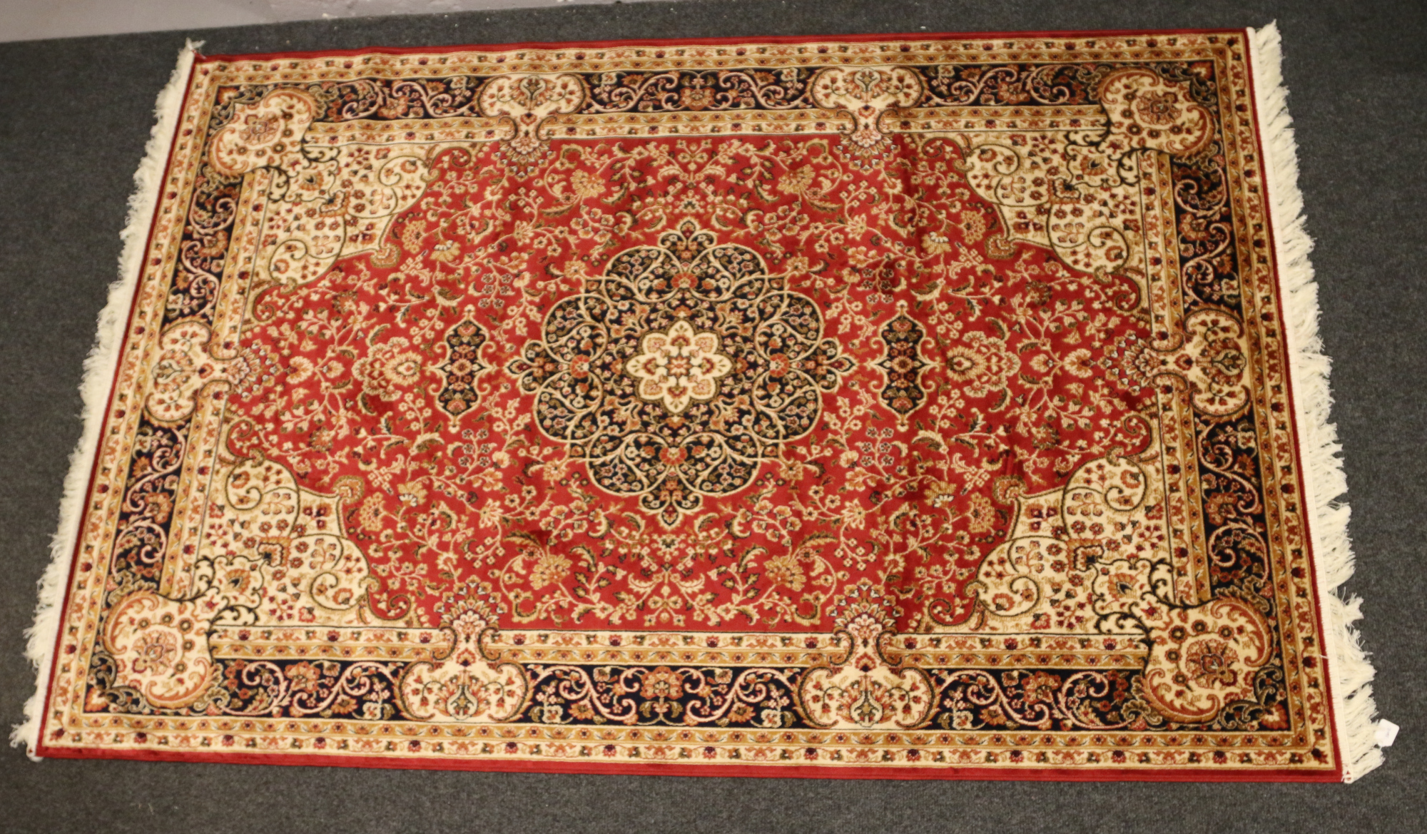 A red ground Keshan carpet, 230cm x 160cm.