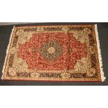 A red ground Keshan carpet, 230cm x 160cm.