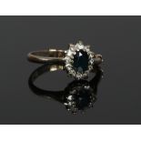 An 18ct white gold, sapphire and diamond cluster ring with 9ct gold sizing bar. Gross weight 2.69