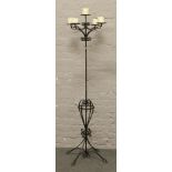 A painted wrought iron five branch candle stand, 180cm tall.