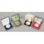 Four cased Royal Mint silver proof commemorative coins.