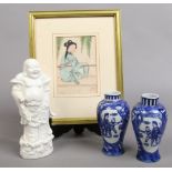 A Blanc De Chine figure of a Buddha, along with a pair of Chinese baluster vases and a gilt framed