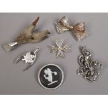 Six silver brooches including a circular example set with a Wedgwood Jasperware tablet, a bow and