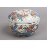 A Japanese Meiji period Imari bowl and cover decorated with flowers. Underglaze four character