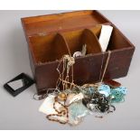 A stained wood three compartment box and contents including postcards, brooches, vintage buttons,