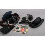 A Canon T50 35mm SLR film camera with Canon 50mm lens, two Cobra lenses, instruction manual 244T hot