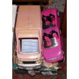 A box of Barbie dolls and related vehicles.