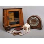 A carved oak smokers cabinet with contents of smoking items to include pipes, cigars etc along