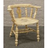 A painted smokers bow arm chair with stencil decoration.