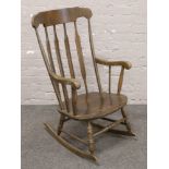 A slat back rocking chair.