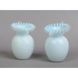 A pair of Victorian coloured glass specimen vases with ribbon moulding and crimped rims.