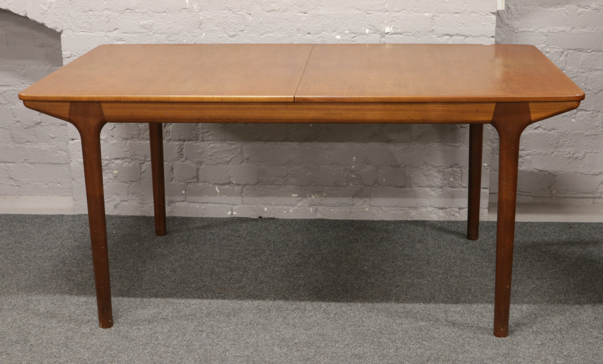 A McIntosh & Co. Limited retro teak extending dining table with two inbuilt bi fold leaves.Condition