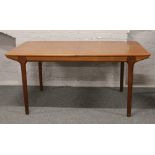 A McIntosh & Co. Limited retro teak extending dining table with two inbuilt bi fold leaves.Condition