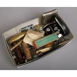 A box of collectables including a boxed set of T. Simmons sovereign balance scales, penknives with