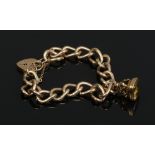 A 9 carat gold curb bracelet with heart shaped clasp and fob seal. With citrine matrix carved with a