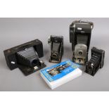A Polaroid land camera model 150 and three other Bellows cameras including Kodak tourist, Agta and