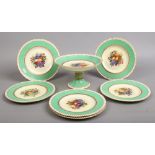 A George Jones & Sons pottery dessert service by W. Birbeck. Gilded, with green ground borders and