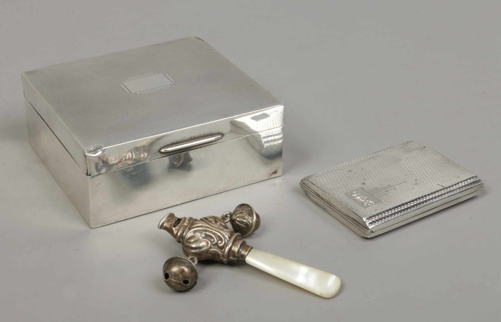 A silver cigarette box assayed Birmingham 1939, a silver Art Deco match case assayed Birmingham 1939