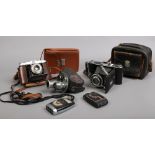 A collection of vintage cameras including Solida Jr Bellows camera, Univex AF-2 miniature, Ensign