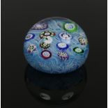 After Baccarat, a Perthshire glass spaced millefiori paperweight with scattered canes reserved on