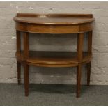 A George V carved mahogany two tier bow front side table raised on square tapering legs. (H -