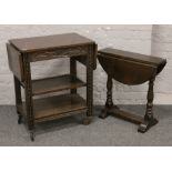 A carved oak drop leaf tea trolley along with an oak drop leaf occasional table.