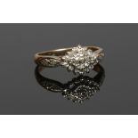 A 9ct gold diamond cluster ring set within a navette formed table, 0.15ct, size H.