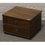A miniature chest of two mahogany drawers.