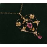 An Edwardian 9ct gold pendant and chain set with two tourmaline stones.