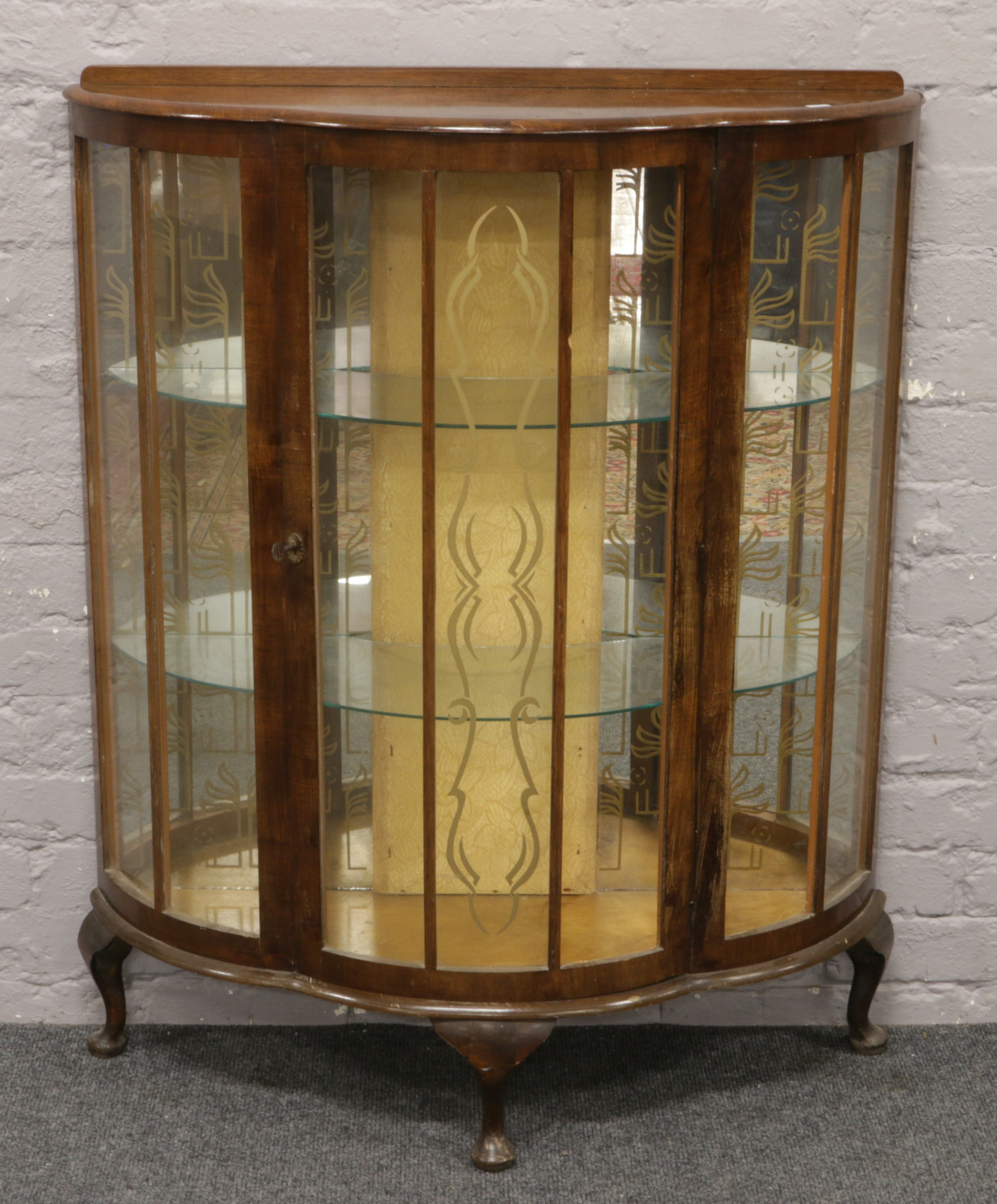 A mahogany bow front china display cabinet raised on squat cabriole legs.Condition report intended