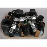 A box of vintage SLR cameras and lenses including Praktica LB, Zenit-B Mamiya MSX 500 and Fujica