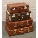 Four vintage suitcases.