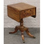 A Regency centre pedestal mahogany work table with drop leaves and drawers.