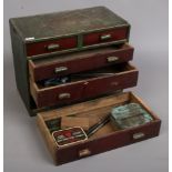 A painted miniature chest of five drawers and contents of engineering tools and vintage